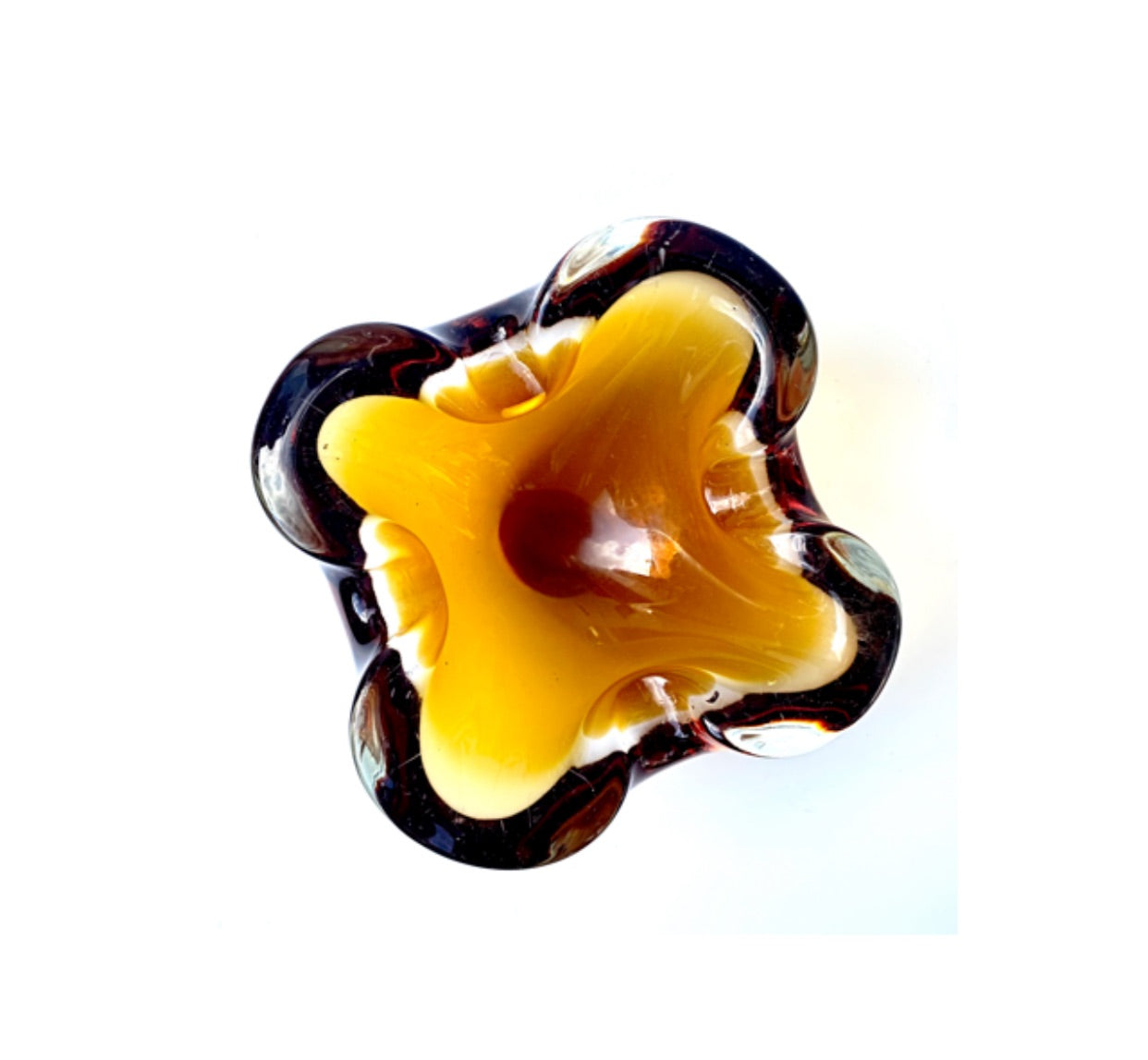 A Murano glass bowl in deep and golden amber.