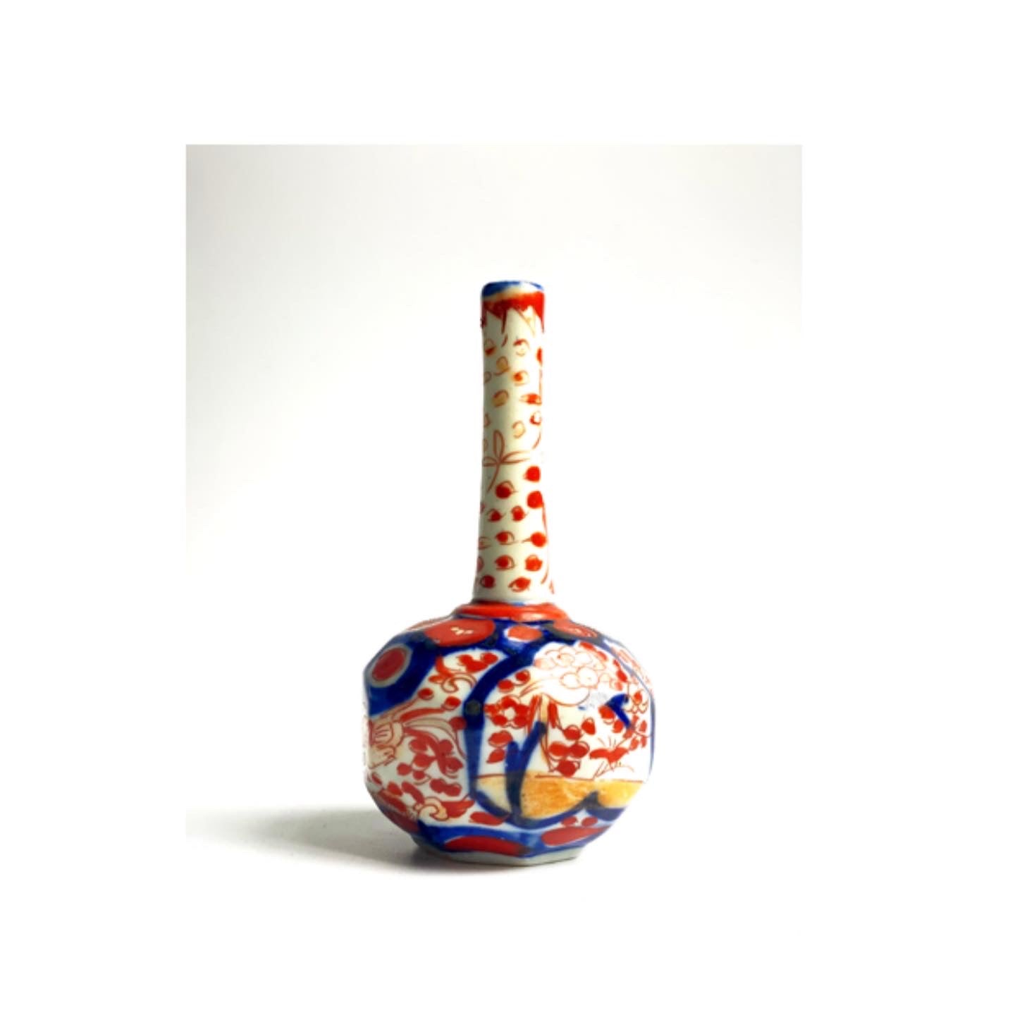 An Imari ceramic bud vase .