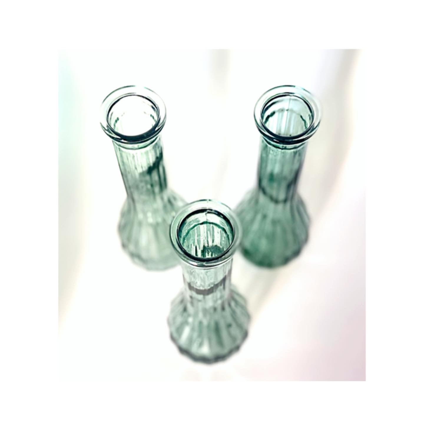 A trio of vintage sage green glass vases or jugs