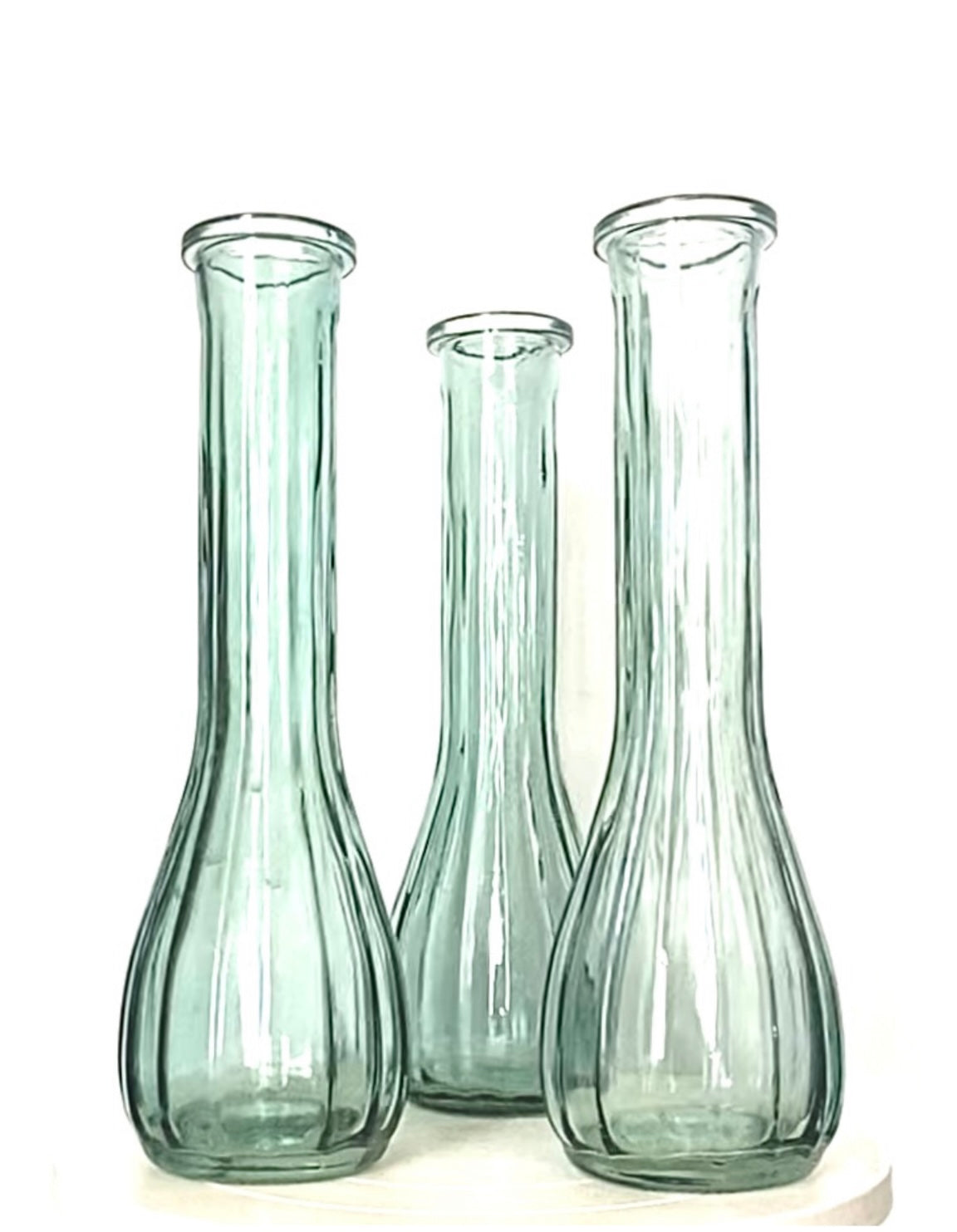 A trio of vintage sage green glass vases or jugs