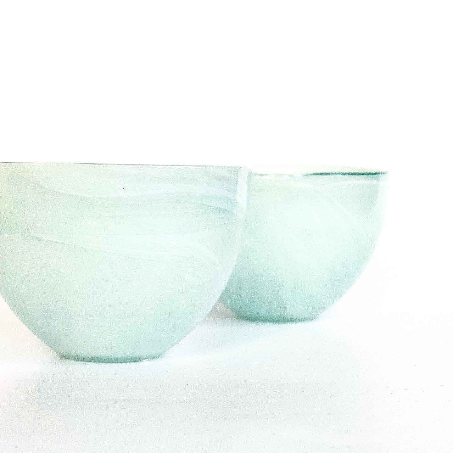 A pair of alabaster bowls in a soft mint green.