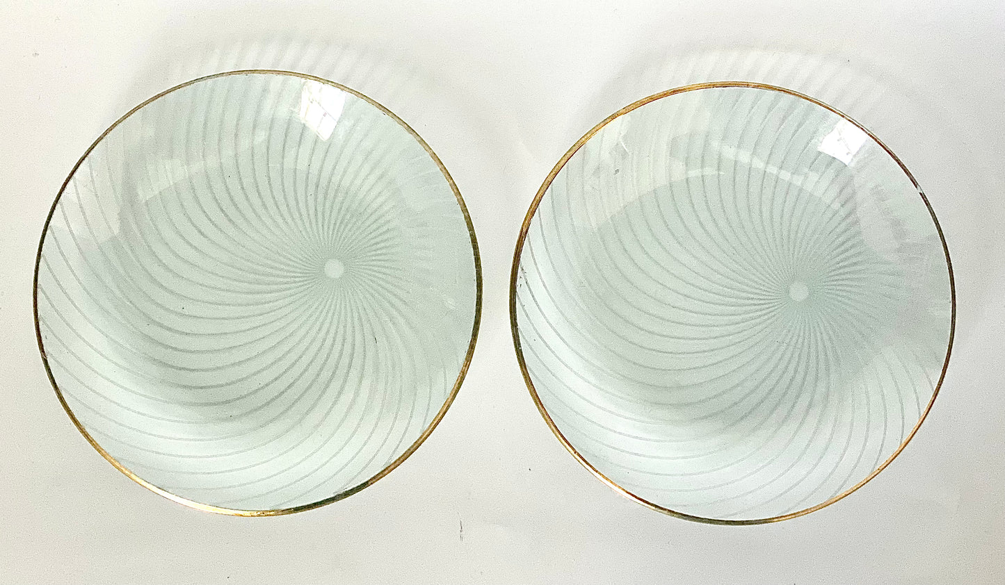 A pair of Whitefriars glass pin dishes with a gold lustred rim.