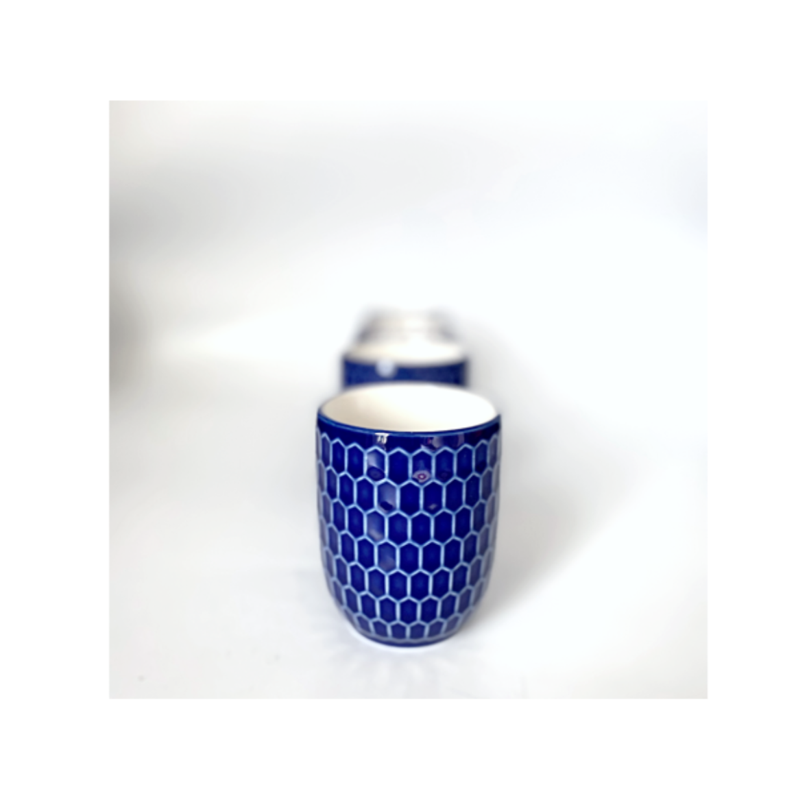 A navy blue and white ceramic cup / mug